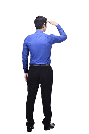 Portrait of asian businessman looking up something standing isolated over white backgroundの写真素材