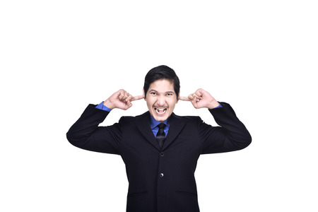 Portrait of asian business man covering ears with his hand isolated over white backgroundの写真素材