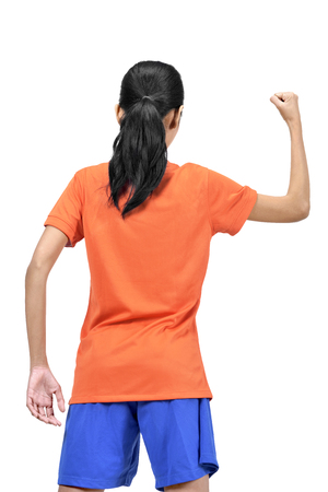 Back view of asian female football player with happy expression isolated over white backgroundの写真素材