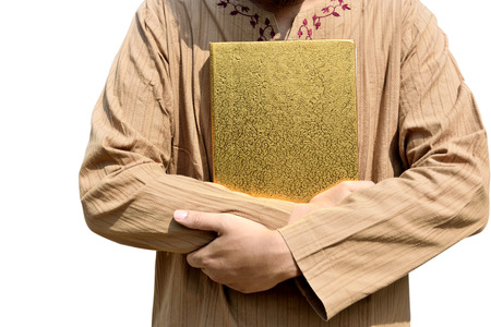 Muslim man holding Koran isolated over white backgroundの写真素材