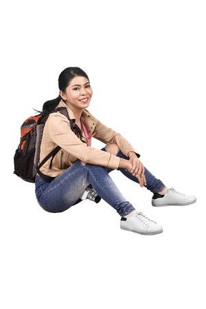 Images of asian traveler woman with backpack and camera sitting isolated over white backgroundの写真素材