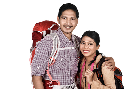 Happy asian couple tourist with backpack standing isolated over white backgroundの写真素材
