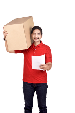 Portrait of asian male courier with parcel and recipient address isolated over white backgroundの写真素材