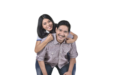 Romantic asian couple in love having fun together posing isolated over white backgroundの写真素材
