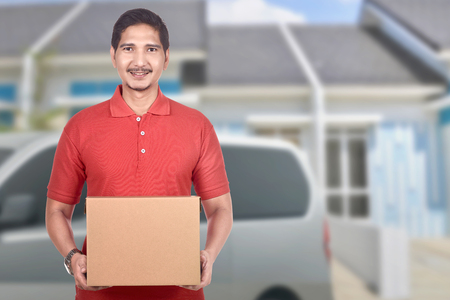 Young asian delivery man deliver the parcel to homeの写真素材