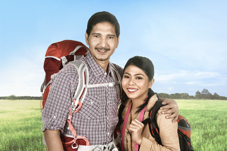 Smiling asian traveler couple relaxing and enjoying the trip at natureの写真素材