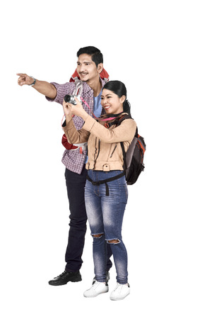 Images of asian couple traveler hunting a photos isolated over white backgroundの写真素材