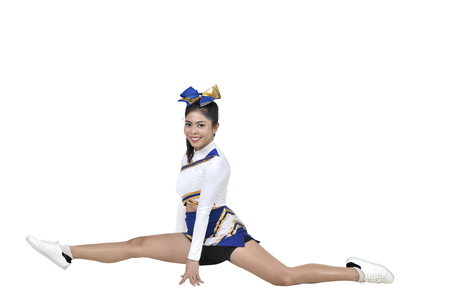 Beautiful asian cheerleader doing splits isolated over white backgroundの写真素材