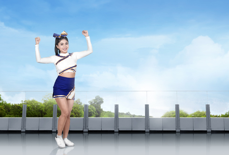 Cute asian cheerleader in action in the buildingの写真素材