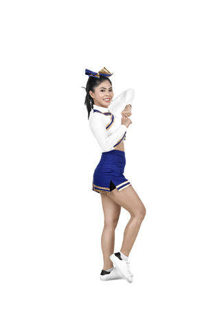 Young asian cheerleader in action isolated over white backgroundの写真素材