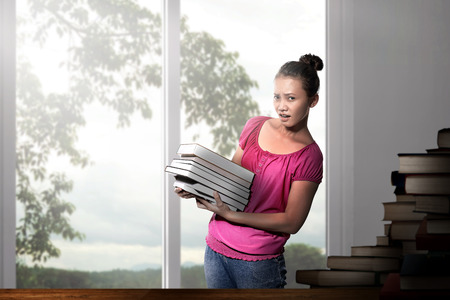 Beautiful asian woman with books on the classroomの写真素材