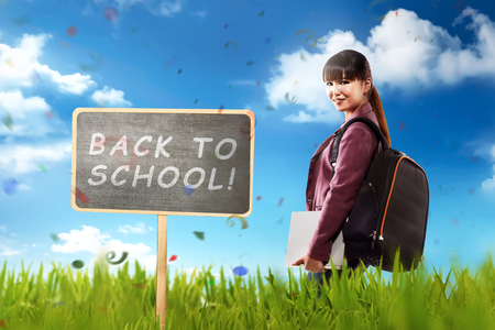 Pretty asian student ready back to school with blue sky backgroundの写真素材