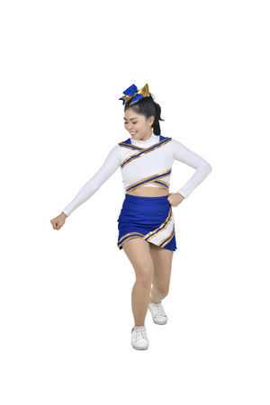 Beautiful asian cheerleader in action posing isolated over white backgroundの写真素材