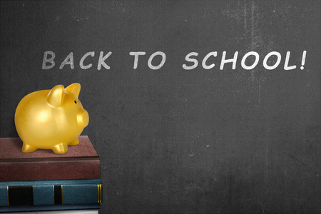 Stack of books with back to school message on the blackboardの写真素材