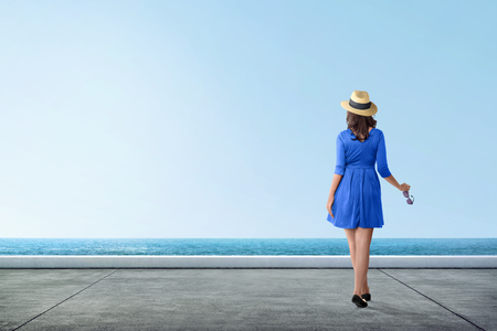 Back view asian tourist woman looking at ocean view from pierの写真素材