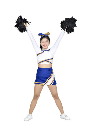 Happy asian cheerleader with pom poms in the air isolated over white backgroundの写真素材