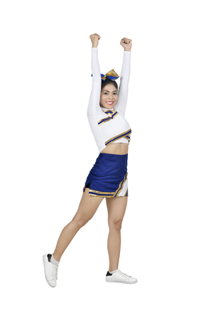 Young asian cheerleader in blue and white suit isolated over white backgroundの写真素材