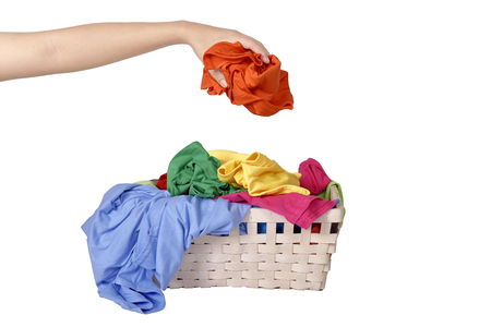 Male hand put the dirty clothes into basket isolated over white backgroundの写真素材