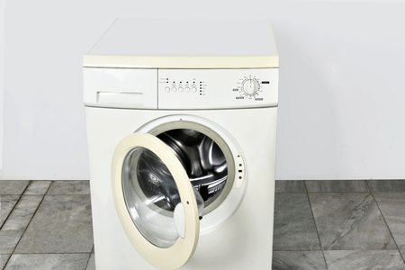 Washing machine with open door in homeの写真素材