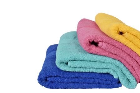 Pile colorful towels isolated over white backgroundの写真素材