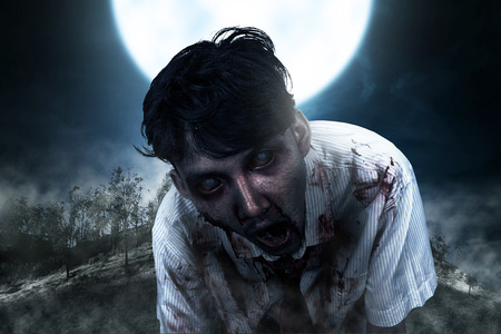 Spooky zombie man with blood hang around on the midnight. Halloween conceptの写真素材
