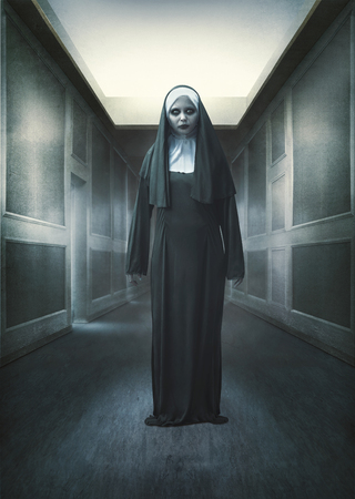 Scary devil nun standing on abandoned place. Halloween conceptの写真素材