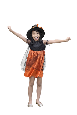 Portrait of asian girl in witch costume and hat standing isolated over white backgroundの写真素材