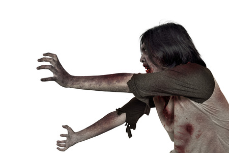 Side view of creepy zombie man with dirty hands standing isolated over white backgroundの写真素材