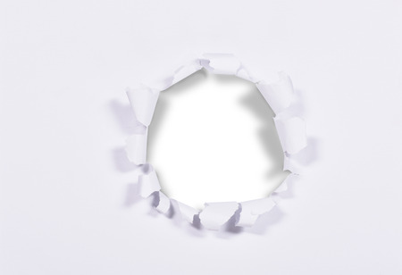 White paper with hole in the middle isolated over white backgroundの写真素材