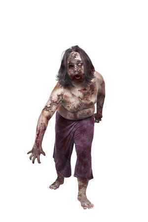 Creepy zombie man with wounded body standing isolated over white backgroundの写真素材