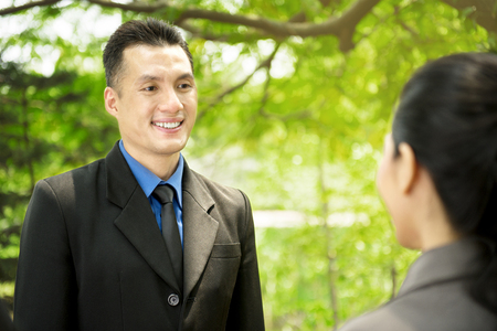 Asian business people discussing work plan at outdoor. Focus on the manの写真素材