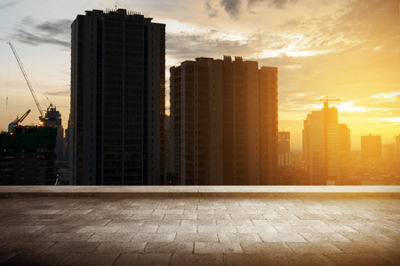 Rooftop view with skyscrapers building and modern city at sunsetの写真素材