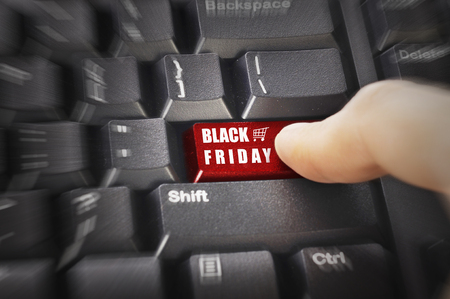 Finger push the red button with Black Friday text on keyboardの写真素材