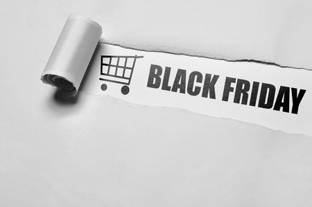 Black Friday message appering behind ripped paper. Black friday conceptの写真素材