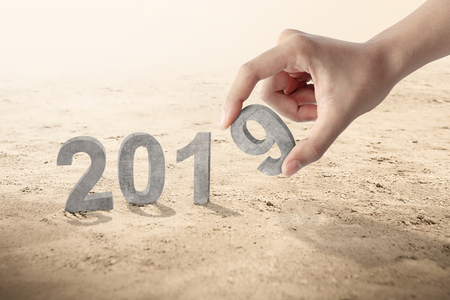 Hand puts number 9 to create 2019. Happy New Year 2019の写真素材