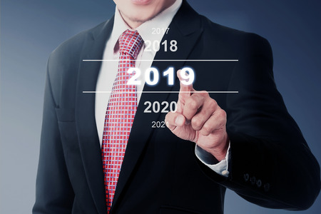 Businessman select 2019 number on digital screen. Happy New Year 2019の写真素材