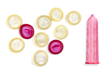 Set of colored condoms isolated over white backgroundの写真素材