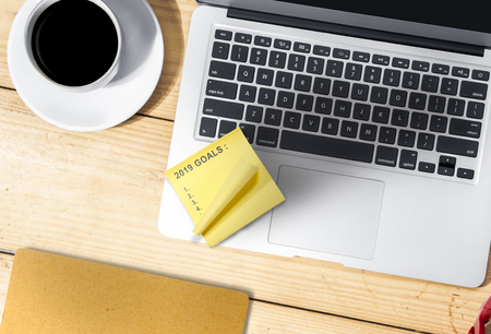 Laptop, coffee and list of 2019 goals in yellow notes. Happy New Year 2019の写真素材