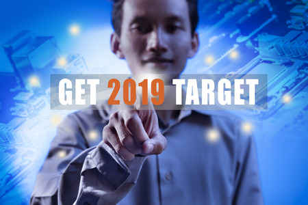 Businessman pointing target in 2019 on digital screen. Business concept. Happy New Year 2019