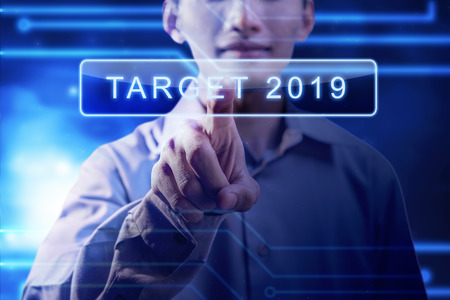 Businessman press the button of Target 2019 on virtual screen. Business concept. Happy New Year 2019の写真素材