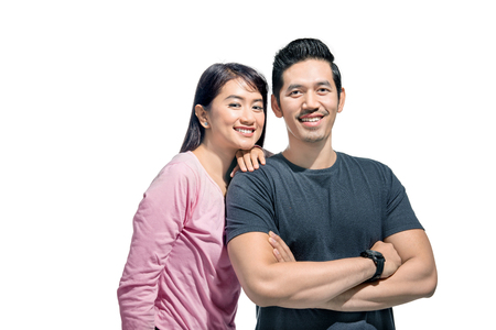Portrait of asian couple smiling isolated over white backgroundの写真素材