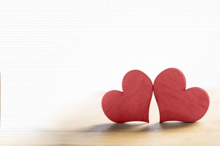 Two red hearts on wooden table with area for copyspace. Love concept and Valentines dayの写真素材