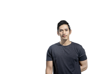 Portrait of asian man with black t-shirt standing isolated over white backgroundの写真素材