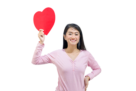 Beautiful asian woman showing red paper hearts posing isolated over white background. Valentines dayの写真素材