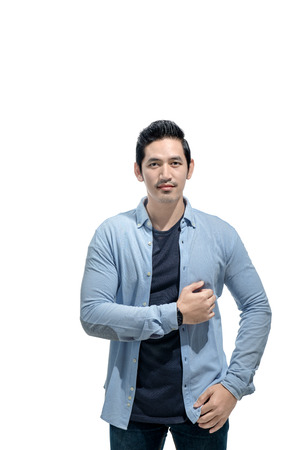Romantic asian man with blue shirt standing isolated over white background. Valentines dayの写真素材