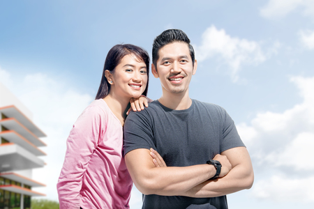 Young asian couple with the woman lean back on the man shoulder at outdoor. Love concept and Valentines dayの写真素材