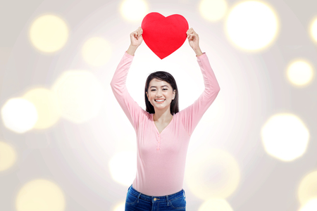 Pretty asian woman with red heart on her hands. Valentines dayの写真素材