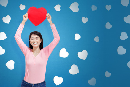 Pretty asian woman with red heart on her hands. Valentines dayの写真素材
