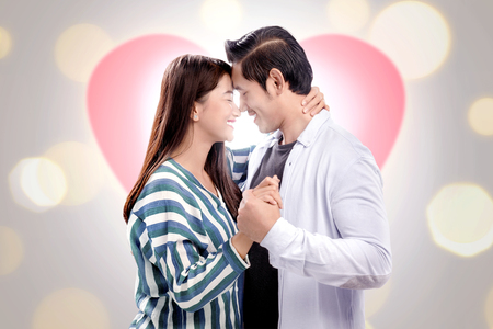 Smiling asian couple in love holding hands and hugging. Love concept and Valentines dayの写真素材