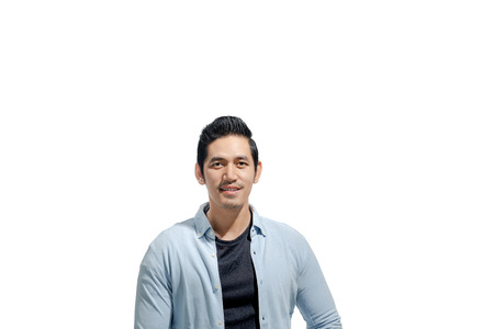 Young asian man with casual cloth standing isolated over white backgroundの写真素材